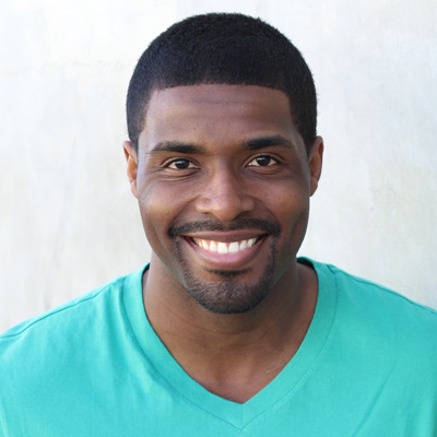 An elderly couple embracing each other with smiles on their faces, posing for a photograph.